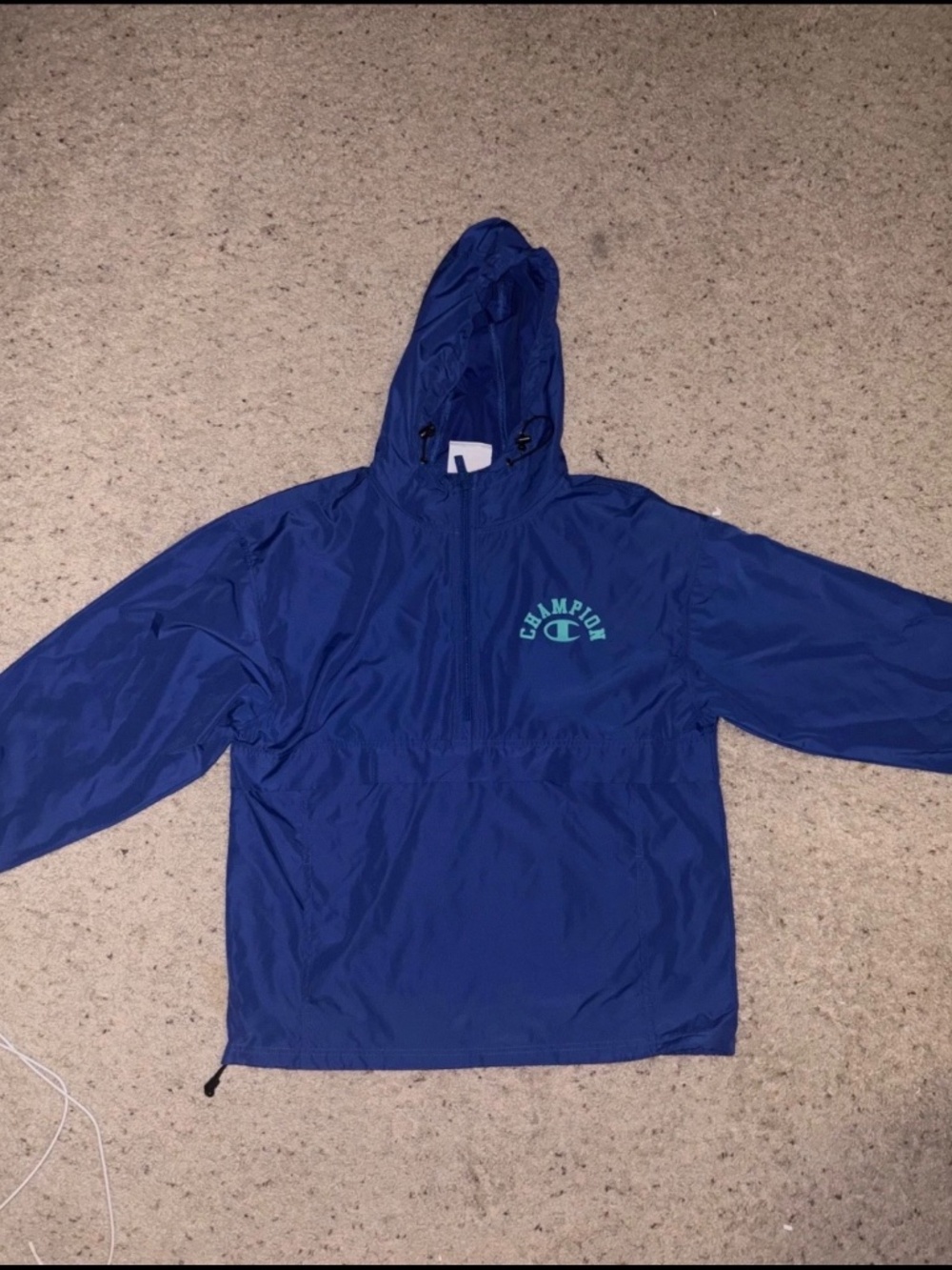 Champion Blue Windbreaker with Champion Graphic on Back. Never worn